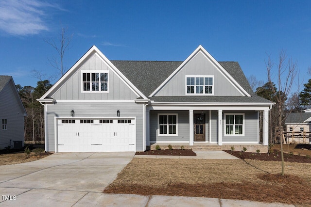 view of front facade featuring concrete driveway, roof with shingles, cooling unit, a porch, and board and batten siding