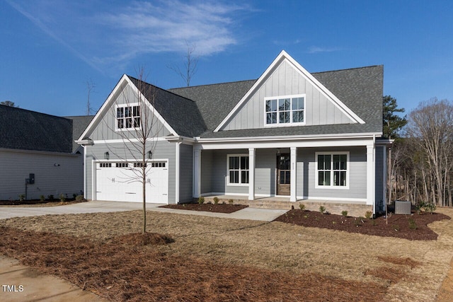 view of front of home featuring covered porch, a garage, concrete driveway, roof with shingles, and board and batten siding