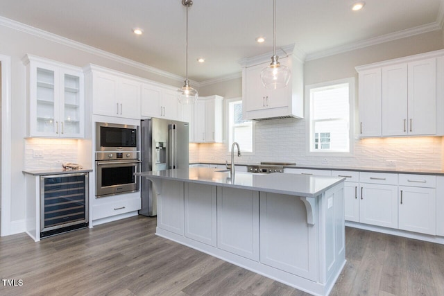 kitchen with crown molding, appliances with stainless steel finishes, dark wood-type flooring, white cabinets, and beverage cooler