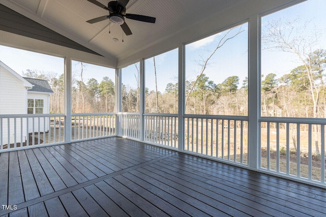 unfurnished sunroom featuring lofted ceiling, ceiling fan, and a wealth of natural light