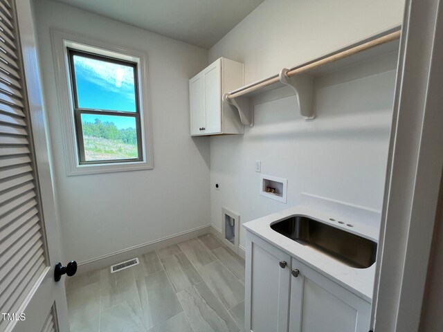 6040 Scalybark Rd, Durham, NC 27712 - washroom featuring hookup for a washing machine, cabinet space, electric dryer hookup, and baseboards