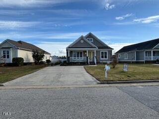 view of front facade with covered porch and a front yard