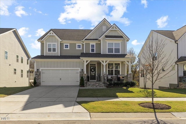 craftsman inspired home with covered porch, a garage, and a front lawn