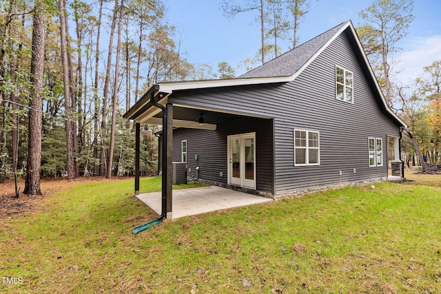 back of house featuring a yard, cooling unit, ceiling fan, and a patio area