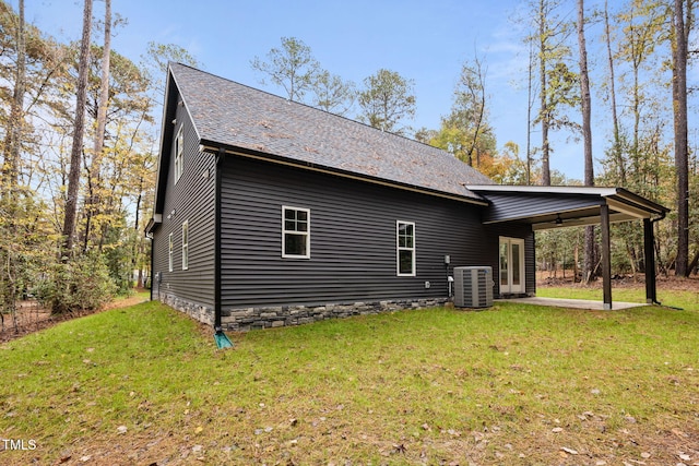 view of property exterior with central AC, a patio area, and a yard