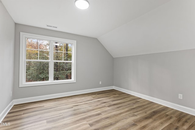 bonus room featuring lofted ceiling and light wood-type flooring