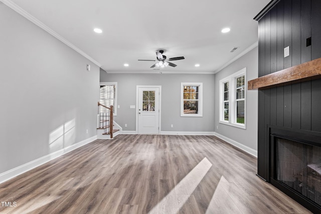 unfurnished living room with light wood-type flooring, ceiling fan, and crown molding