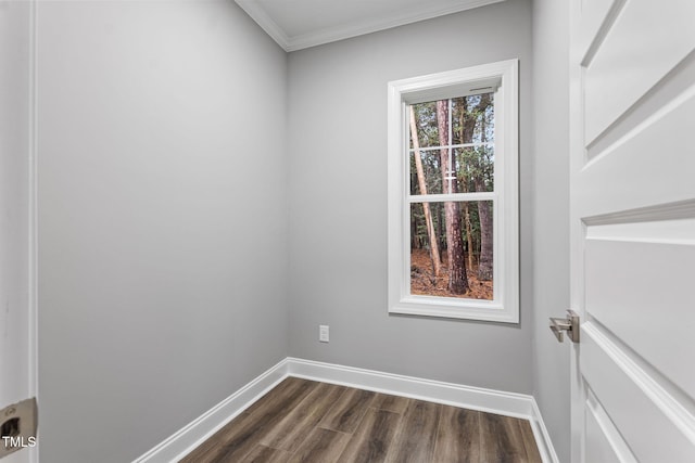 unfurnished room featuring dark hardwood / wood-style floors and crown molding