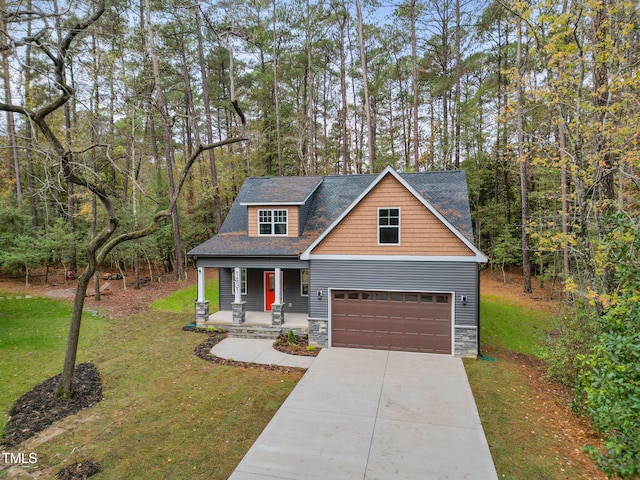 craftsman house with a front yard, a porch, and a garage