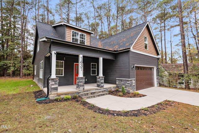 craftsman house with a porch and a garage