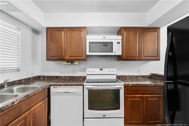 kitchen featuring white appliances and sink