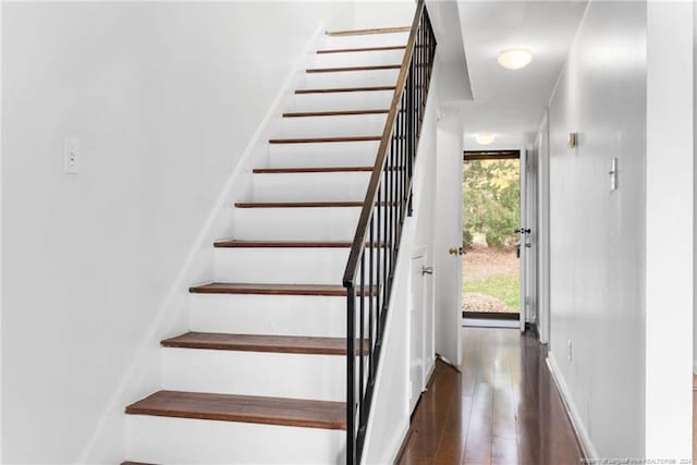 staircase with wood-type flooring