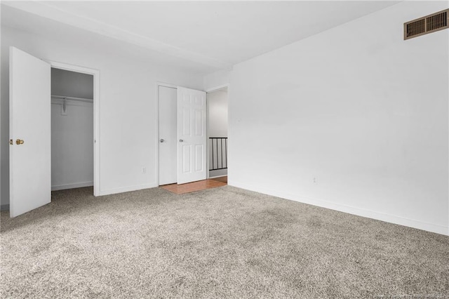 unfurnished bedroom featuring a closet and carpet floors