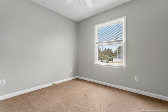 unfurnished room with ceiling fan, carpet floors, and a textured ceiling