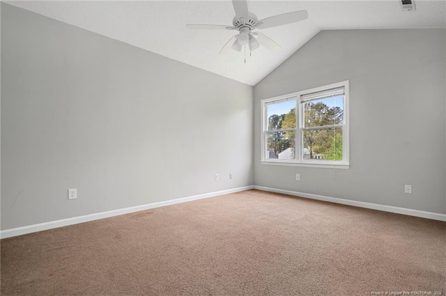 carpeted empty room with vaulted ceiling and ceiling fan