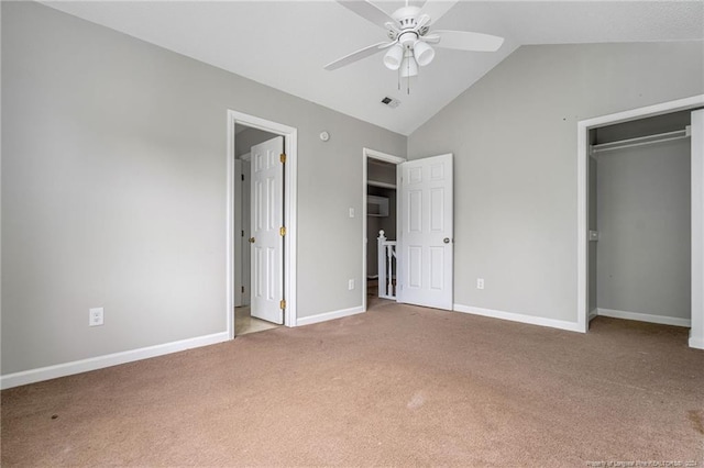 unfurnished bedroom with ceiling fan, a closet, light carpet, and lofted ceiling