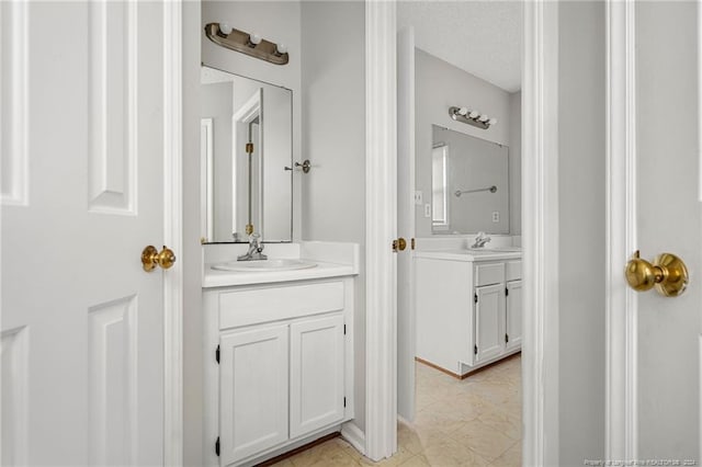 bathroom with vanity and a textured ceiling