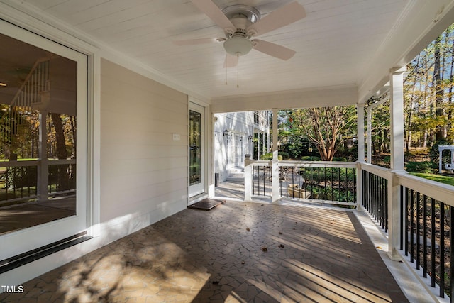 wooden deck with a porch and ceiling fan