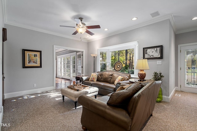 carpeted living room featuring crown molding, french doors, and ceiling fan