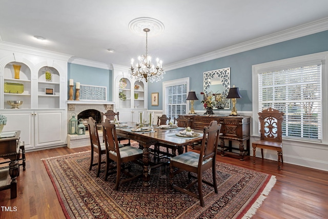 dining room featuring crown molding, an inviting chandelier, and hardwood / wood-style flooring