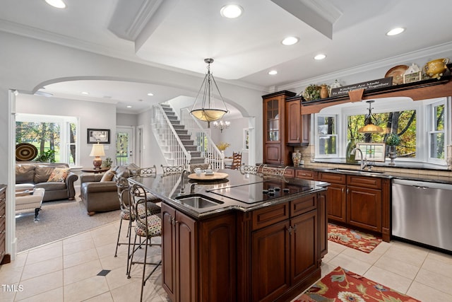 kitchen featuring stainless steel dishwasher, pendant lighting, light tile patterned floors, and a wealth of natural light