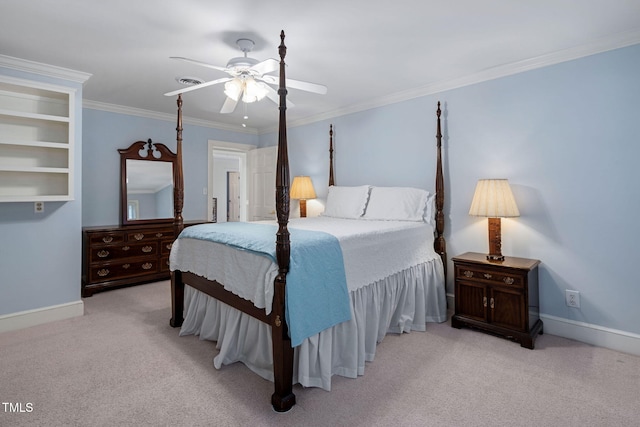 carpeted bedroom with ceiling fan and ornamental molding