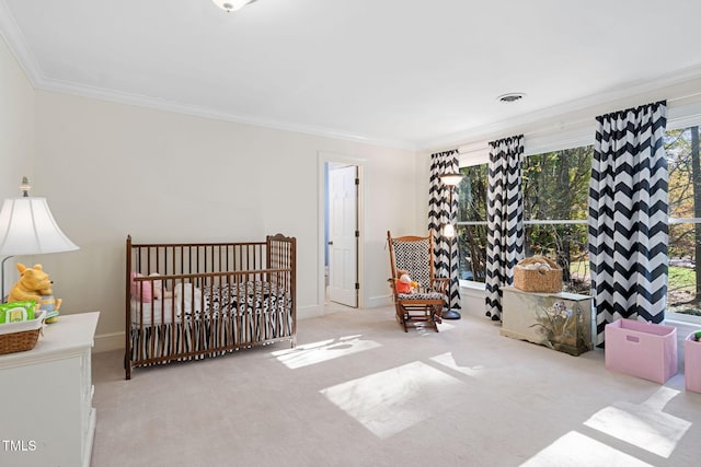 carpeted bedroom featuring a crib and ornamental molding