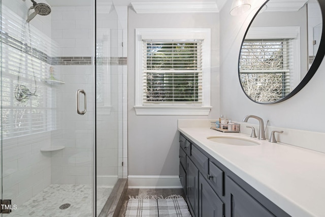 bathroom featuring hardwood / wood-style flooring, vanity, crown molding, and walk in shower