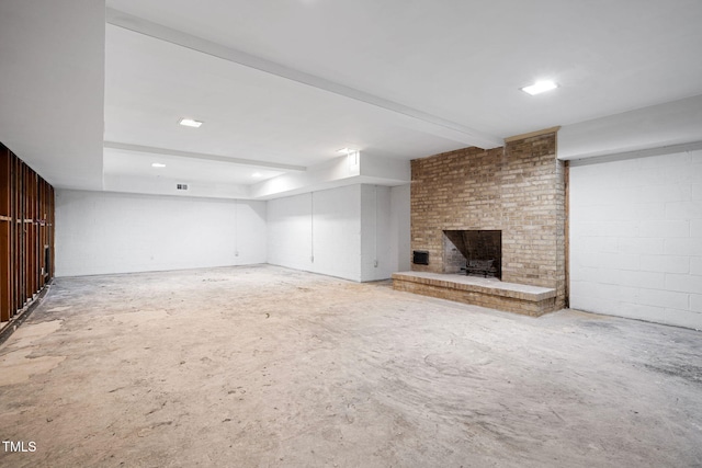 unfurnished living room featuring a fireplace, concrete flooring, and beamed ceiling