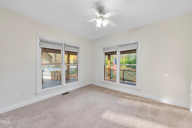 carpeted empty room featuring ceiling fan