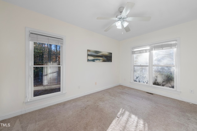 carpeted empty room featuring ceiling fan