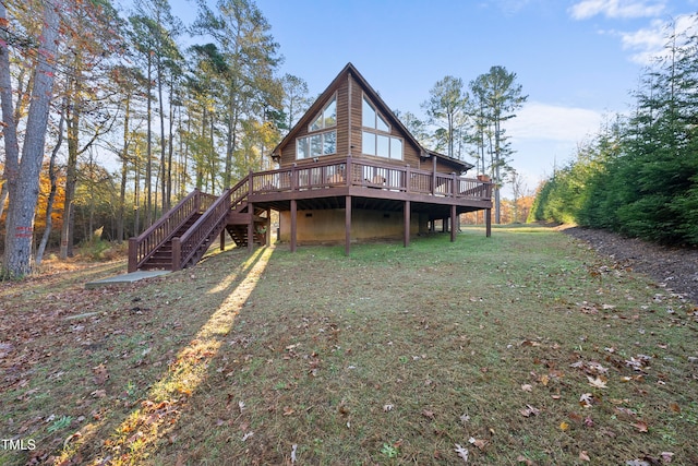 back of property featuring a deck and a yard