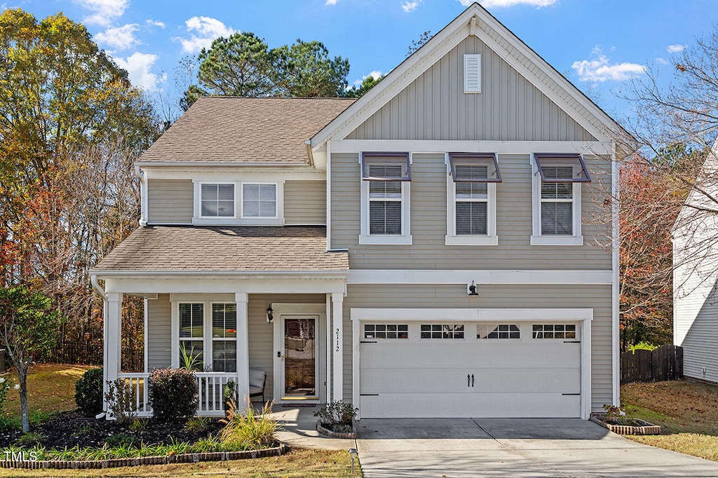 view of front of property with a porch and a garage