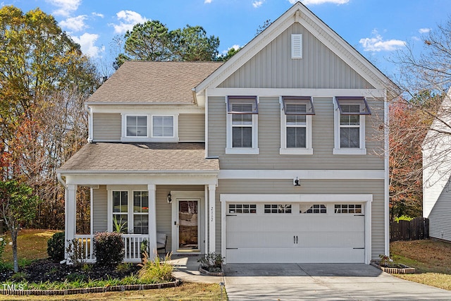 view of front of property with a porch and a garage