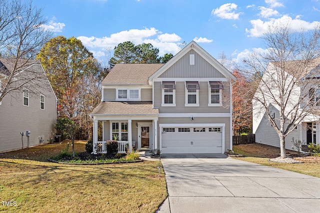 view of property with covered porch, a front yard, and a garage