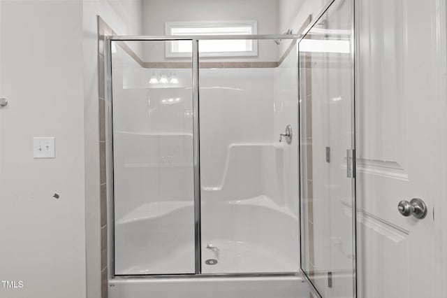 bathroom with a shower with door