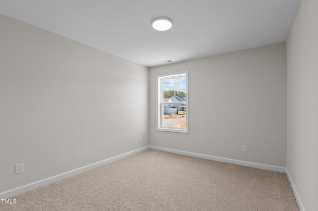 empty room with baseboards and carpet flooring