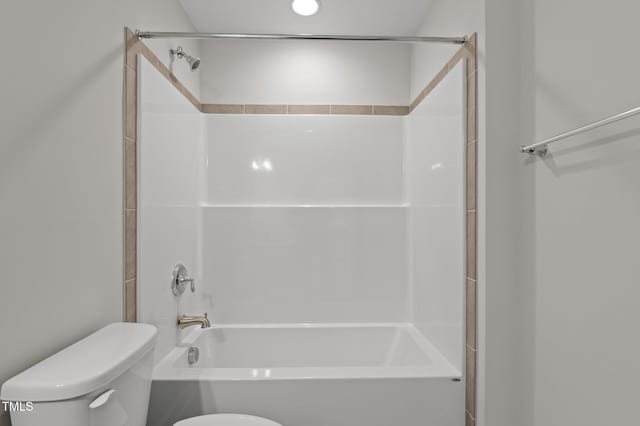 bathroom with toilet and bathing tub / shower combination