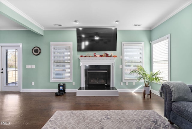 living room with plenty of natural light, wood-type flooring, and crown molding