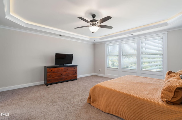 bedroom with light carpet, a raised ceiling, ceiling fan, and ornamental molding