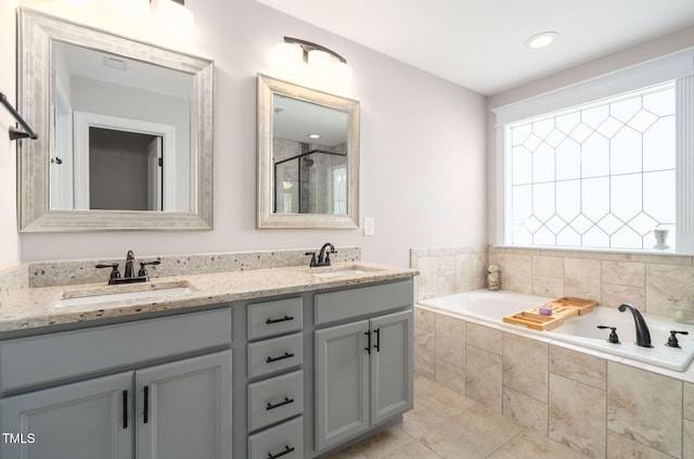 bathroom with separate shower and tub, tile patterned floors, and vanity