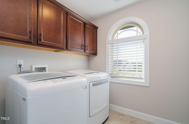 washroom with light tile patterned flooring, cabinets, and independent washer and dryer