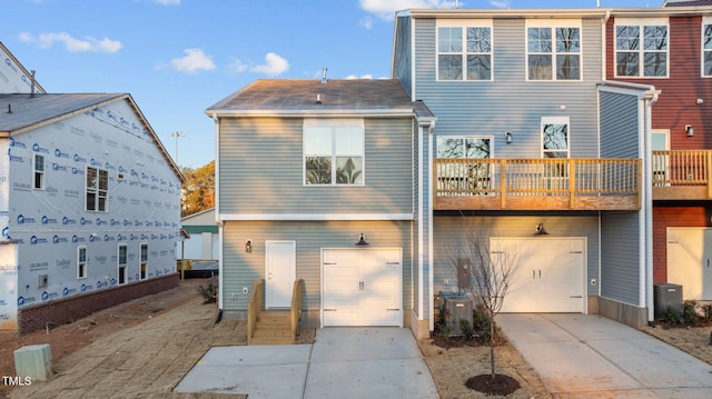 back of house featuring a garage