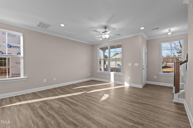 spare room with hardwood / wood-style floors, plenty of natural light, ceiling fan, and crown molding