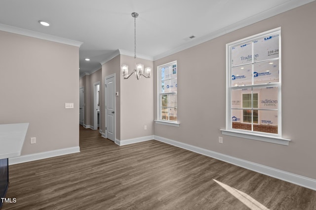 unfurnished dining area with a chandelier, dark wood-type flooring, and ornamental molding