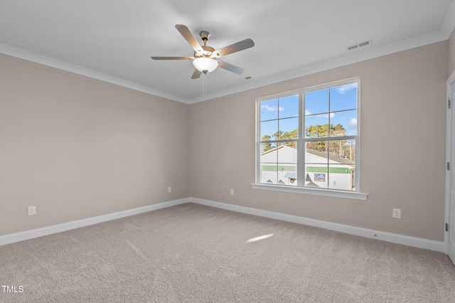 carpeted empty room featuring ceiling fan and ornamental molding