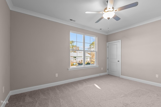 carpeted empty room featuring ceiling fan and ornamental molding