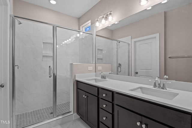 bathroom featuring vanity and an enclosed shower