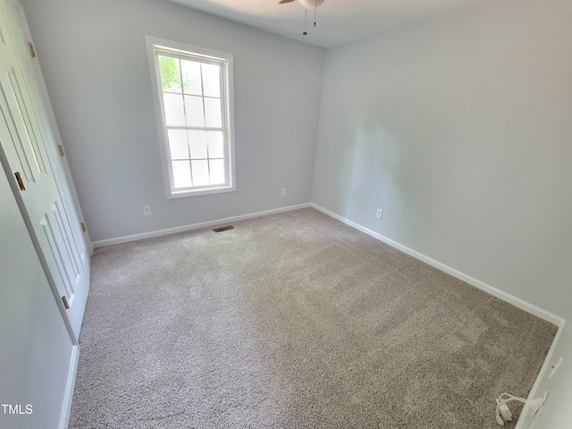 unfurnished room featuring ceiling fan and light carpet