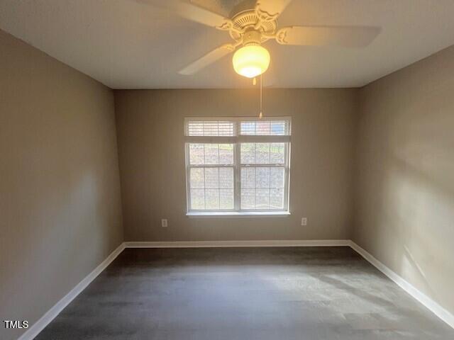 unfurnished room with concrete flooring and ceiling fan